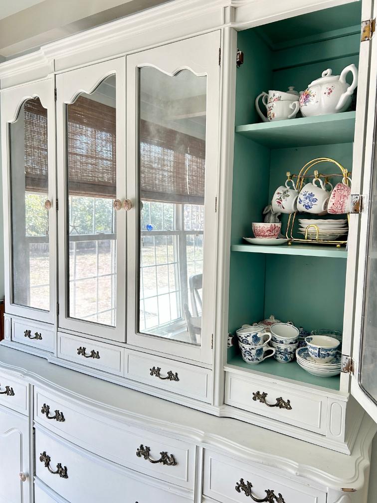 teacup storage and bright blue inside of china hutch